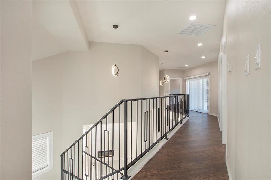Corridor with recessed lighting, an upstairs landing, and dark wood finished floors Corridor with recessed lighting, an upstairs landing, and dark wood finished floors