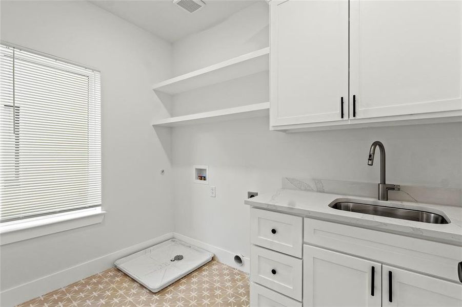 Washroom featuring electric dryer hookup, hookup for a washing machine, cabinet space, and hookup for a gas dryer Washroom featuring electric dryer hookup, hookup for a washing machine, cabinet space, and hookup for a gas dryer