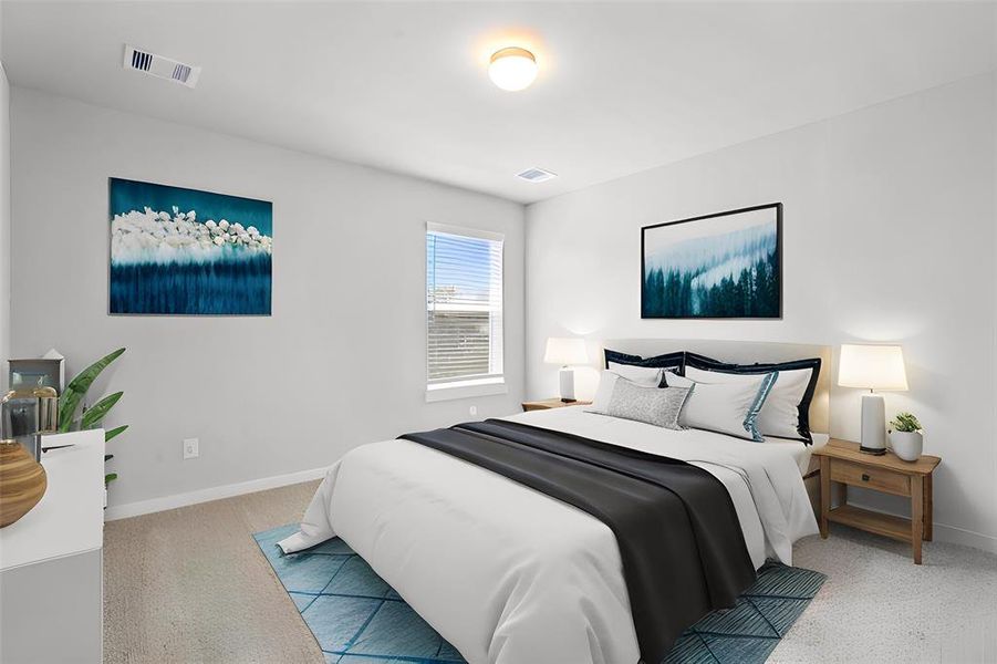 Secondary bedroom features plush carpet, custom paint and a large window with privacy blinds.