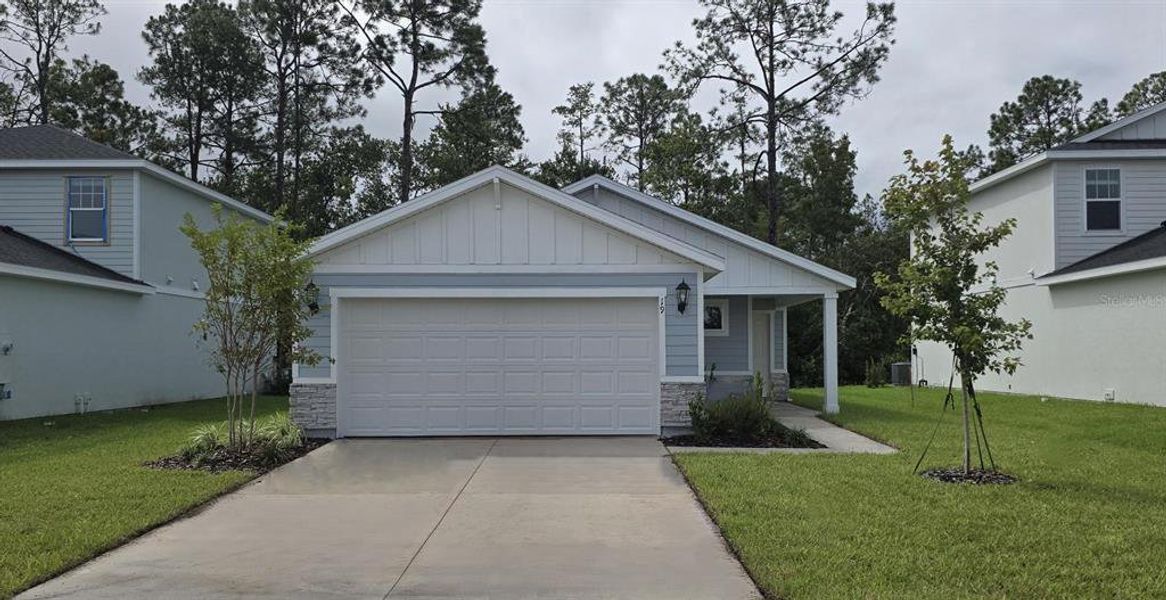 Front exterior of a new home in Flagler Village - Classic Series, Palm Coast, FL, highlighting curb appeal (Image 1).
