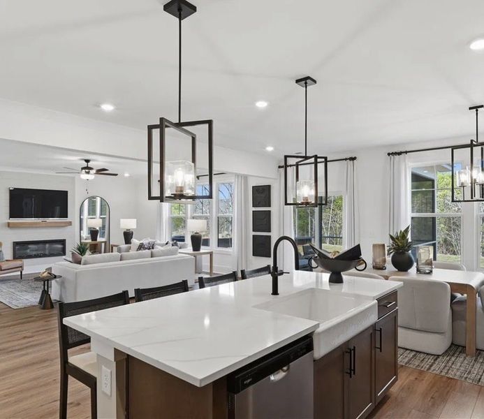 An open-concept living area features a grand kitch An open-concept living area features a grand kitch