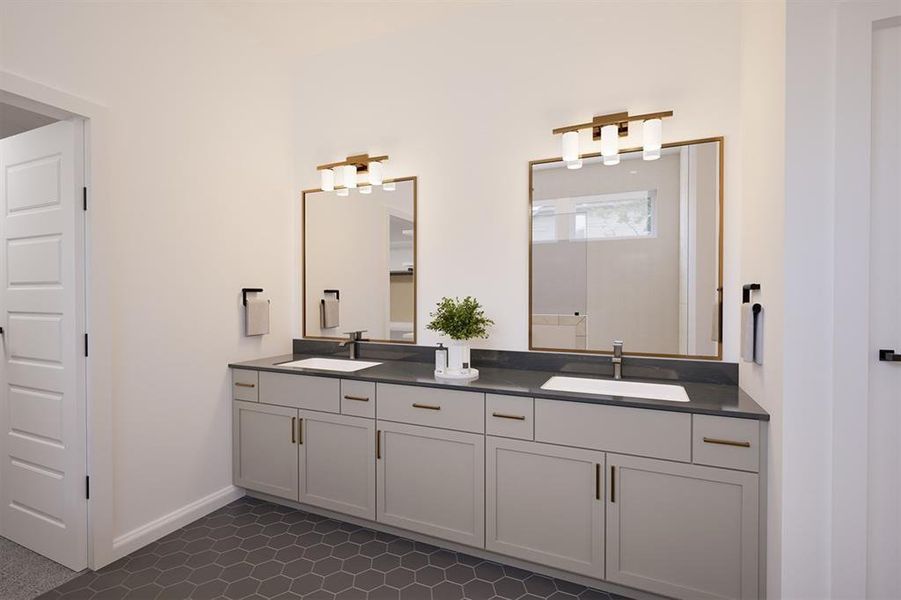 Full bath with double vanity and baseboards