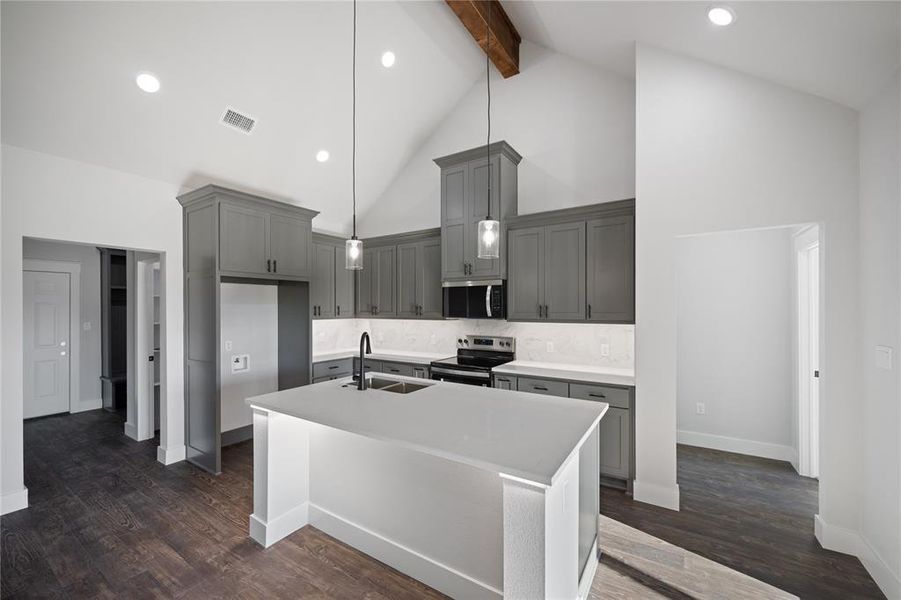 Custom cabinets with undercabinet lighting, as well as undercounter lighting on the island.