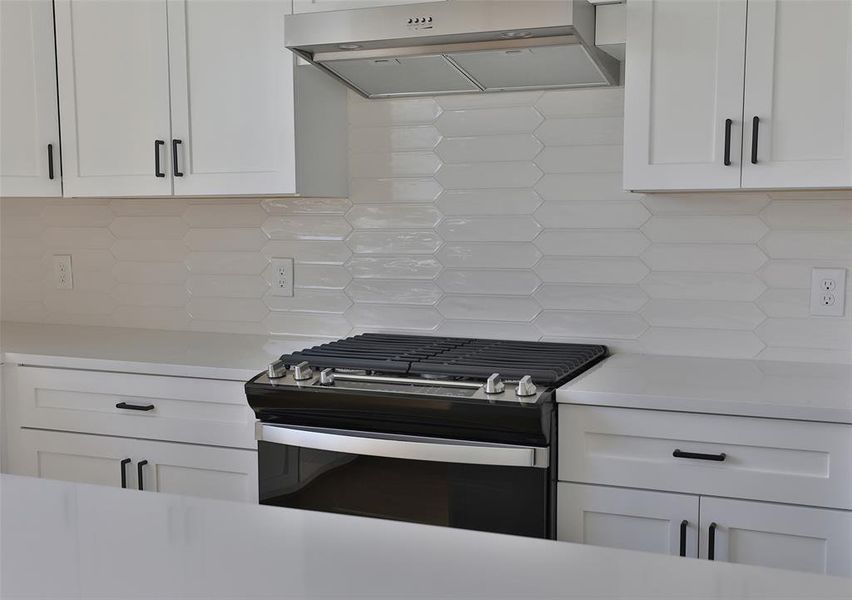 Equipped with stainless steel Whirlpool appliances and a gas range, this kitchen is every chef's dream.