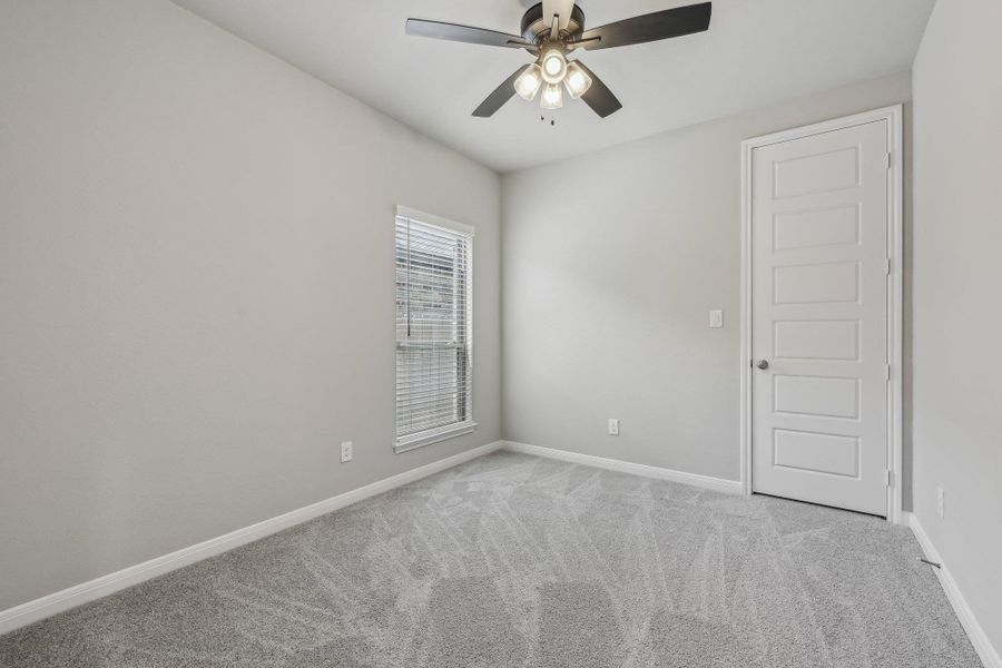 Unfurnished room featuring carpet, baseboards, and a ceiling fan Unfurnished room featuring carpet, baseboards, and a ceiling fan