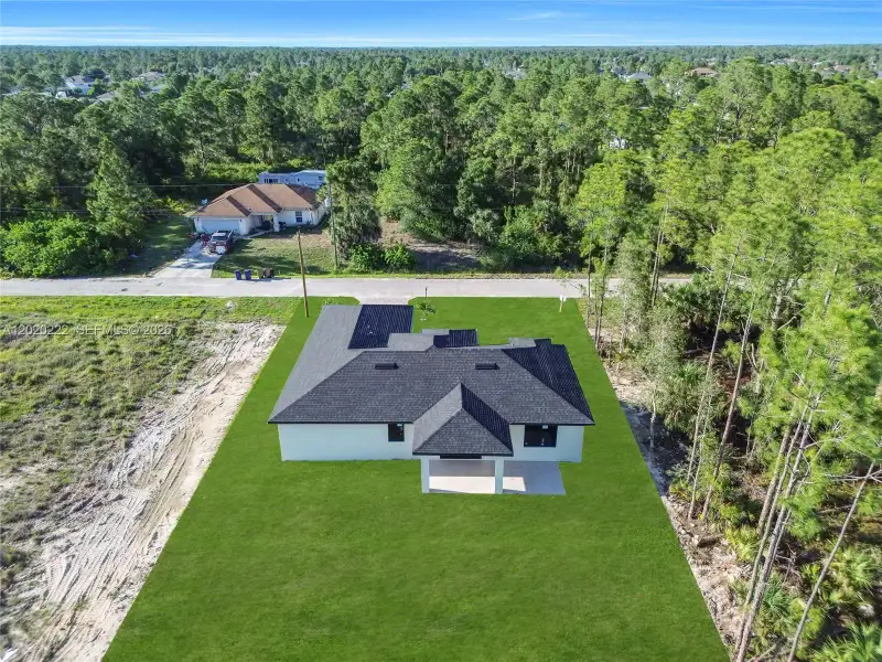 Front exterior of a new home in , Lehigh Acres, FL, highlighting curb appeal (Image 27).