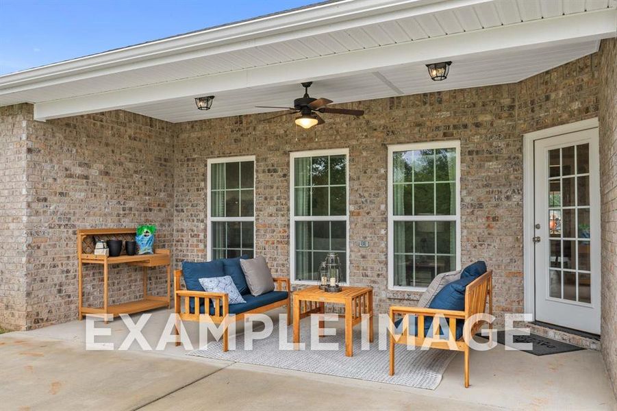 View of patio with outdoor lounge area and ceiling fan