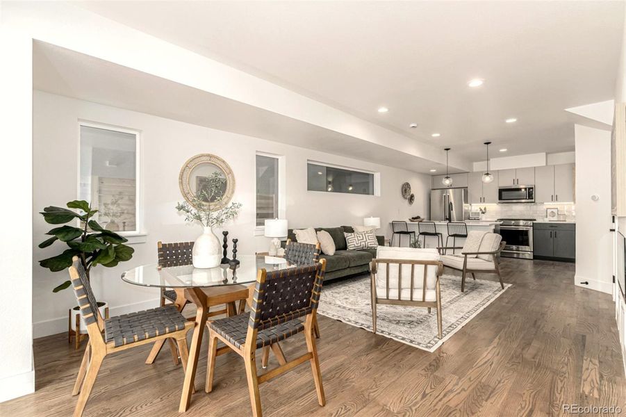 Open plan living, dining and kitchen, with half bath and coat closet on main floor