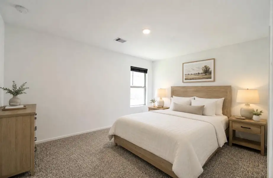 Spacious primary bedroom with brand new carpet.