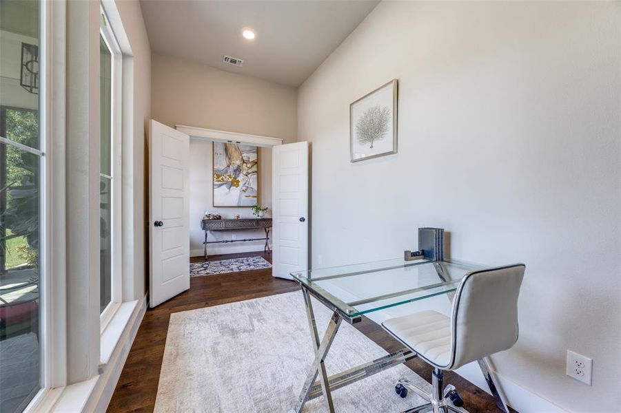 Office area featuring dark wood-type flooring and recessed lighting