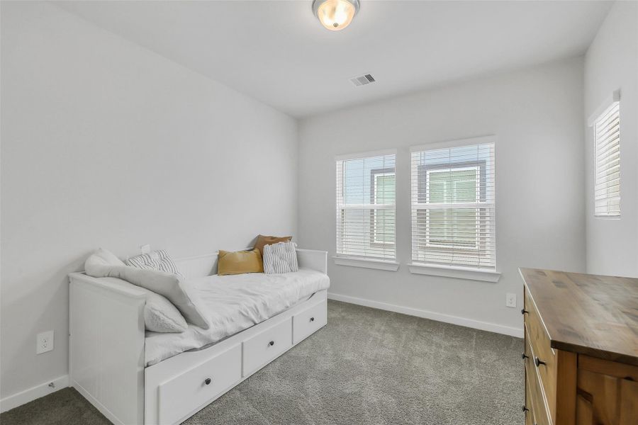 Bright and versatile secondary bedroom offering flexibility for guests, children, or a home office setup.