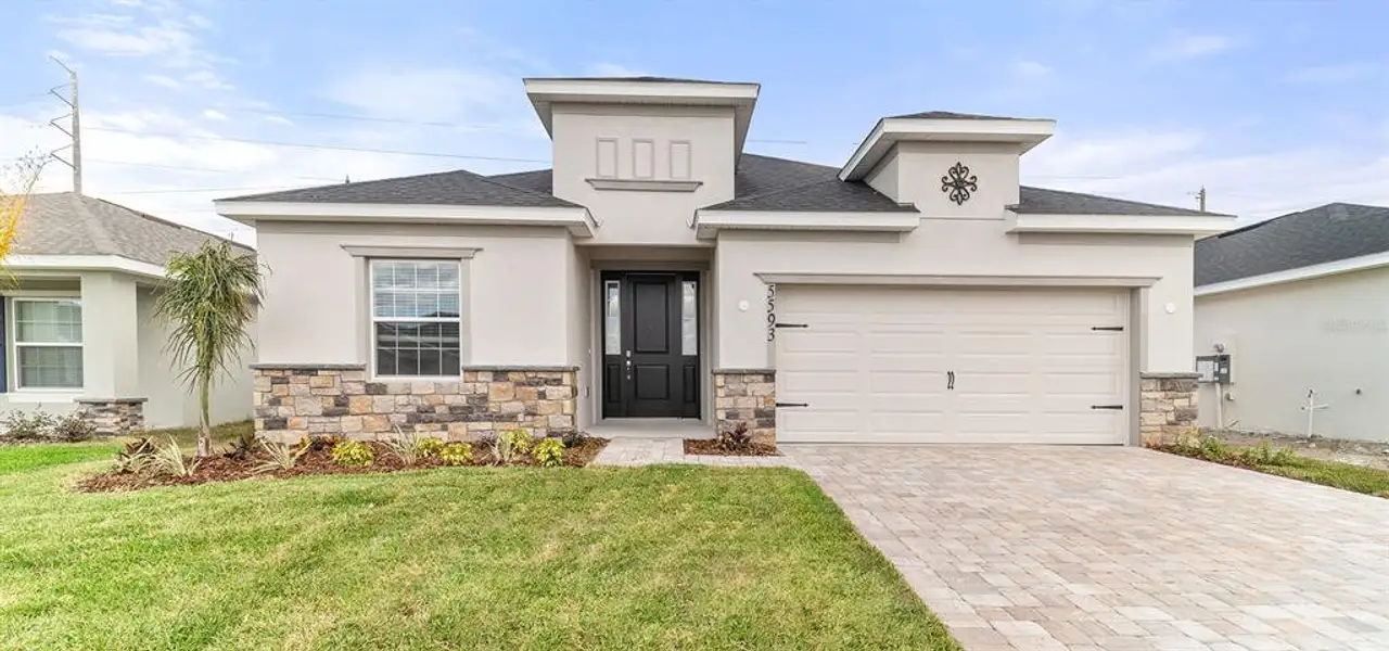 Front exterior of a new home in Estates at Hickory Cove - Single-Family Homes, St. Cloud, FL, highlighting curb appeal (Image 1). Front exterior of a new home in Estates at Hickory Cove - Single-Family Homes, St. Cloud, FL, highlighting curb appeal (Image 1).