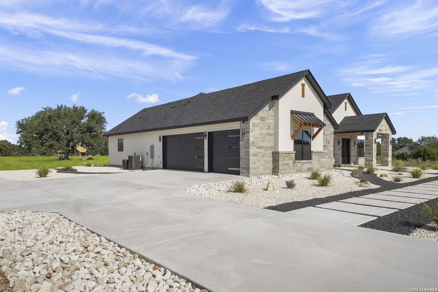 Front exterior of a new home in , Bandera, TX, highlighting curb appeal (Image 26).