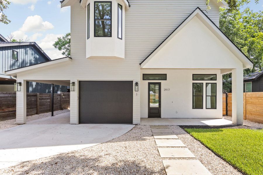 View of front of property with driveway and a garage View of front of property with driveway and a garage