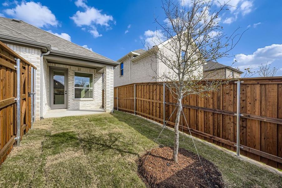 Fenced backyard with a patio area Fenced backyard with a patio area