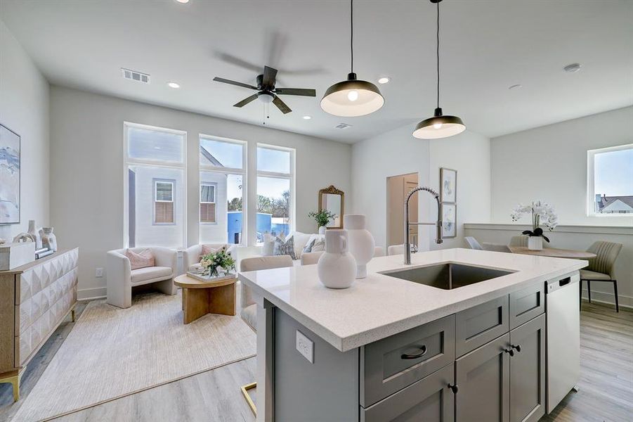 Kitchen includes quartz countertopsand undermount stainless steel sinkon the island.