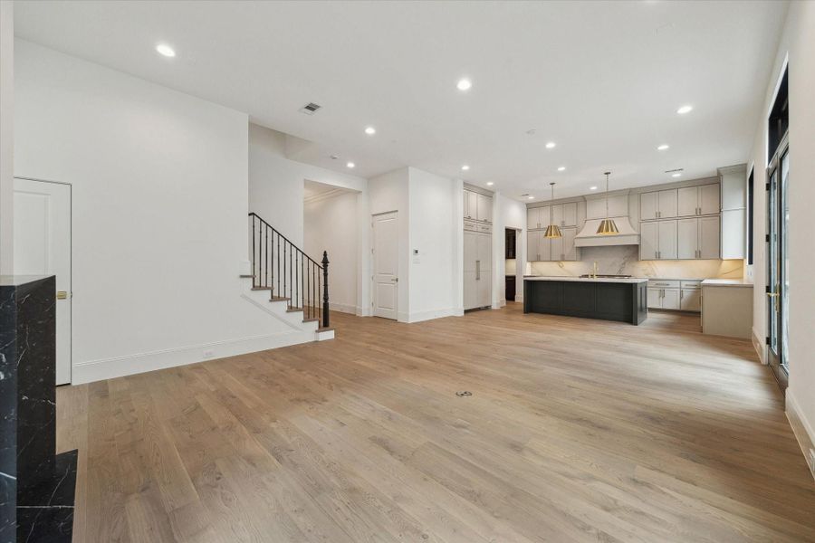 The stunning first floor was designed with relaxation and entertaining in mind! Spacious enough for ample seating surrounding the fireplace, a large dining table, and an island with additional seating that overlooks the living space.