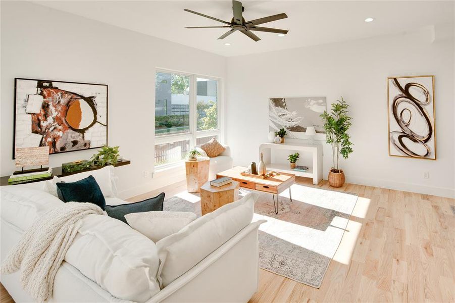 Living room featuring light hardwood / wood-style floors and ceiling fan