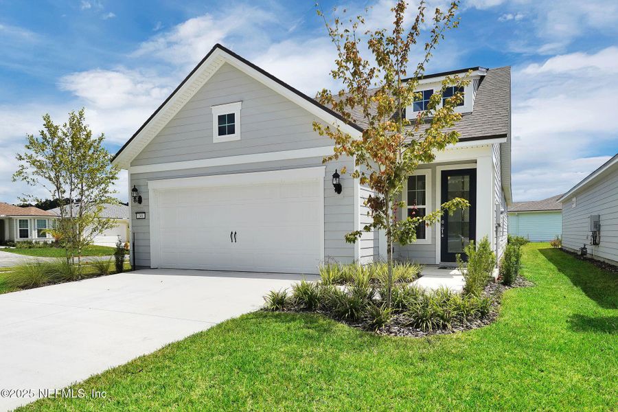 Front exterior of a new home in Summer Bay at Grand Oaks, St. Augustine, FL, highlighting curb appeal (Image 19).