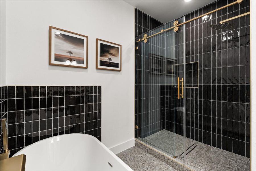 The bold tile and warm brass finishes give the bathroom a boutique hotel feel. The bold tile and warm brass finishes give the bathroom a boutique hotel feel.