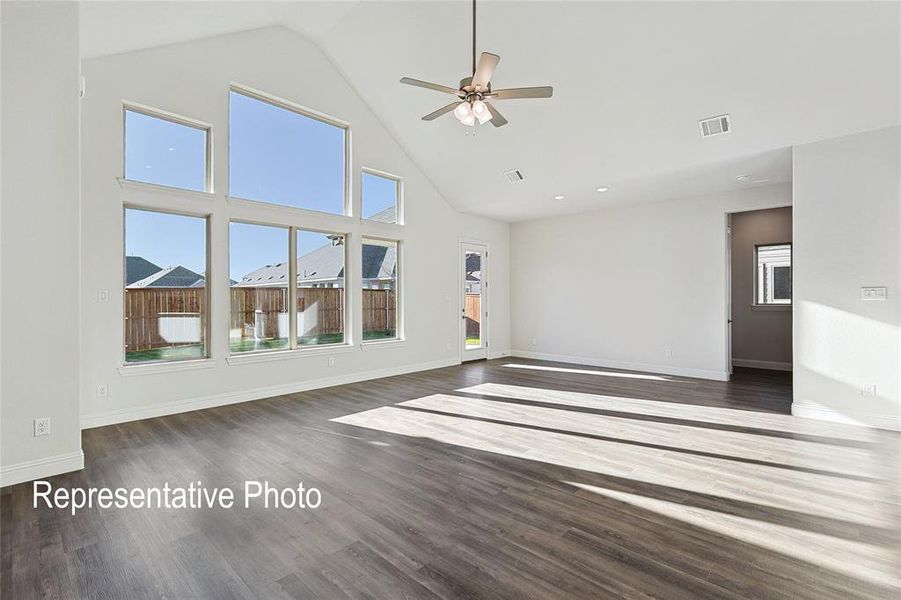 Unfurnished living room with ceiling fan, high vaulted ceiling, and hardwood / wood-style floors