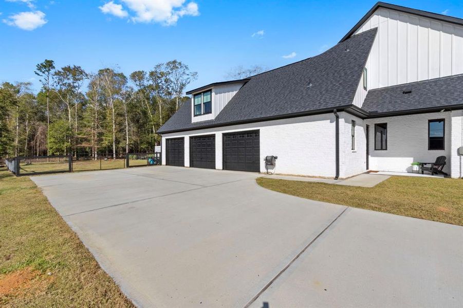 Three large oversized garages with plenty of parking in front.