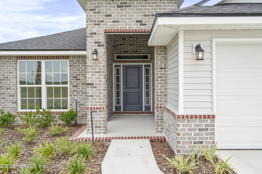 Front exterior of a new home in Shadow Crest at Rolling Hills, Green Cove Springs, FL, highlighting curb appeal (Image 14).