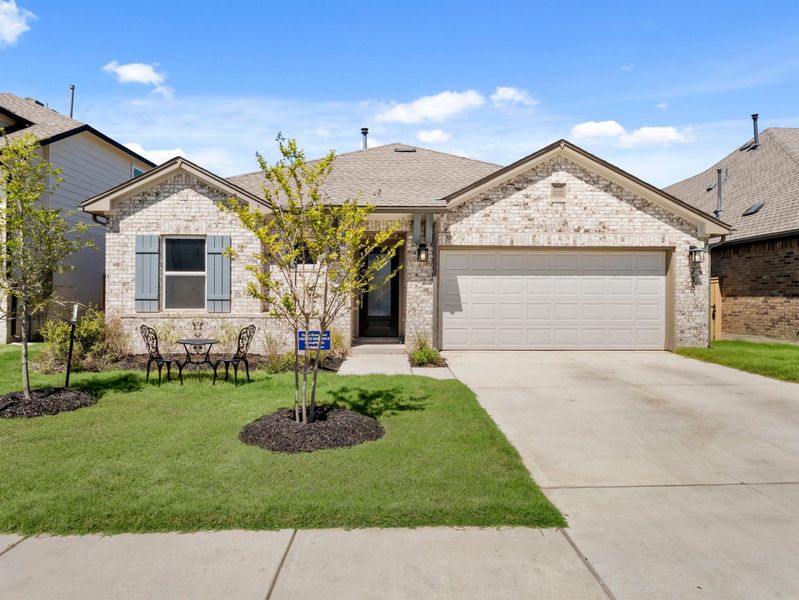 Front exterior of a new home in The Colony, Bastrop, TX, highlighting curb appeal (Image 2). Front exterior of a new home in The Colony, Bastrop, TX, highlighting curb appeal (Image 2).
