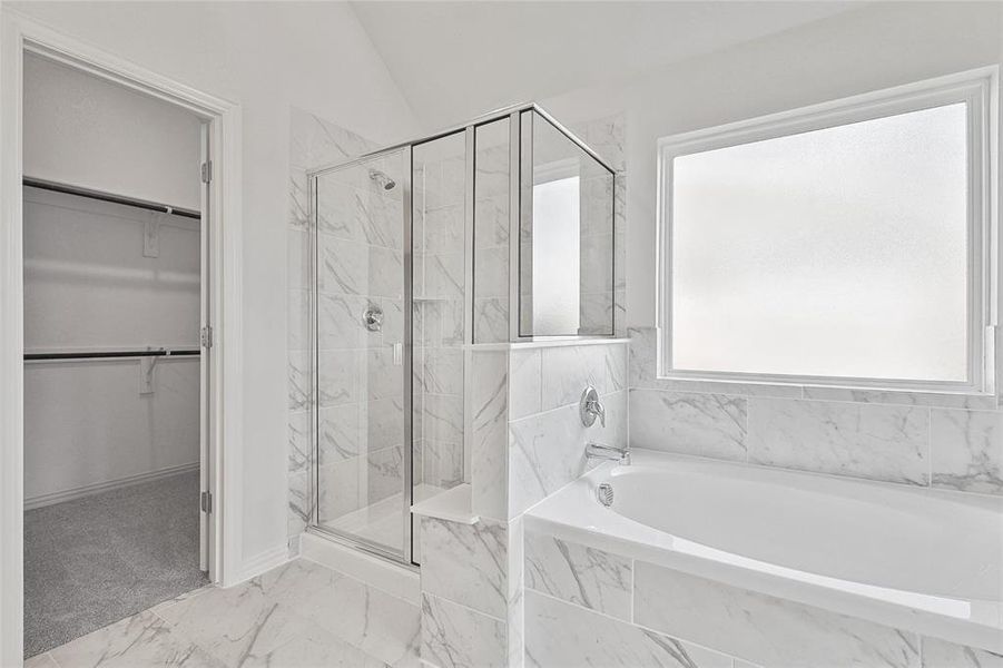 Bathroom with lofted ceiling, separate shower and tub, and tile patterned flooring