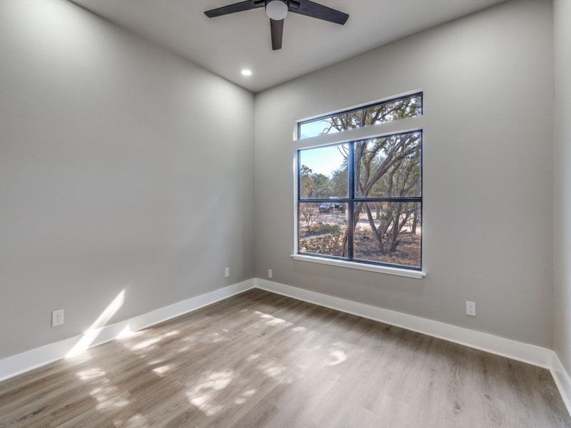 Spare room featuring light wood finished floors, a ceiling fan, and recessed lighting