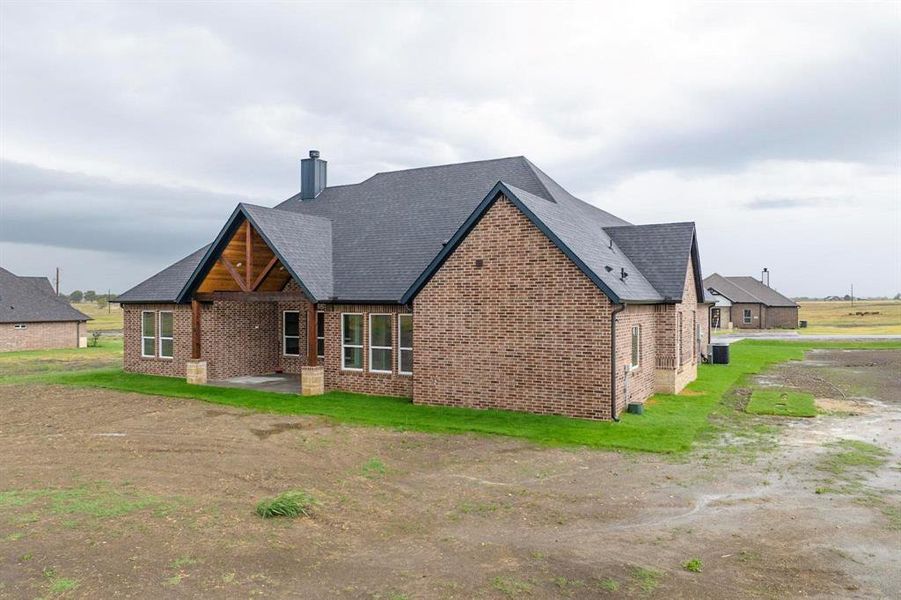 Rear view of house featuring a patio area and cooling unit