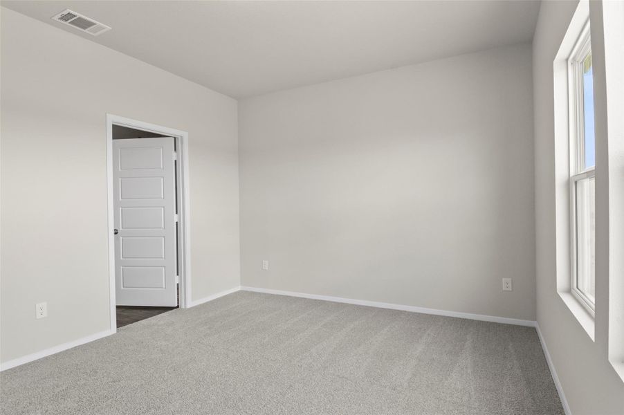 Carpeted spare room featuring baseboards Carpeted spare room featuring baseboards