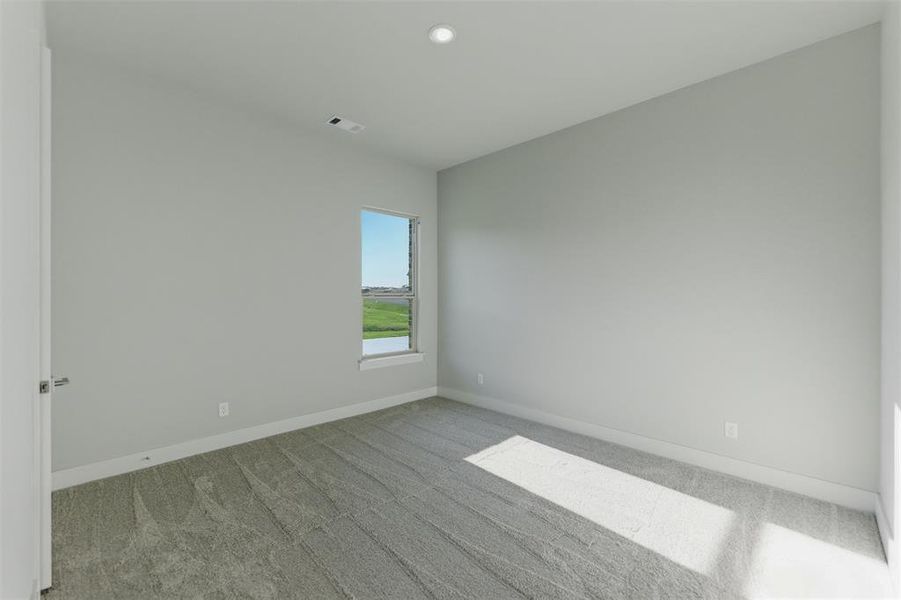 Empty room featuring light carpet and recessed lighting
