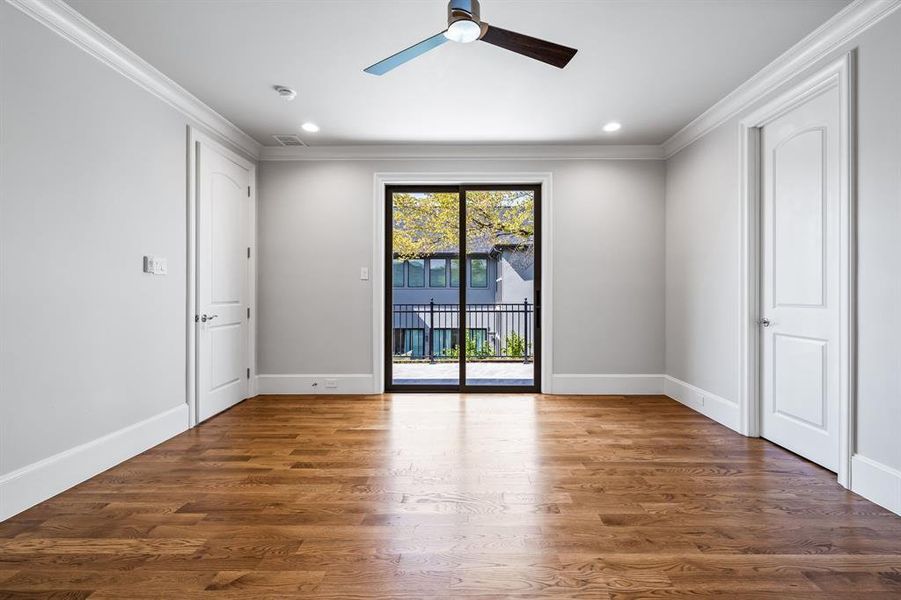 Spare room featuring ceiling fan, crown molding, and wood-type flooring