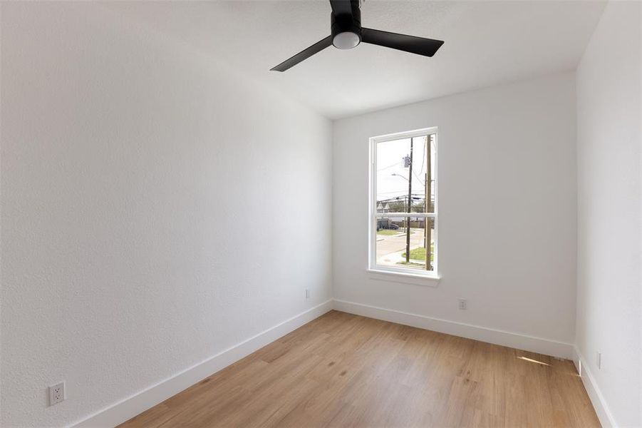 Unfurnished room with light wood-type flooring and a ceiling fan
