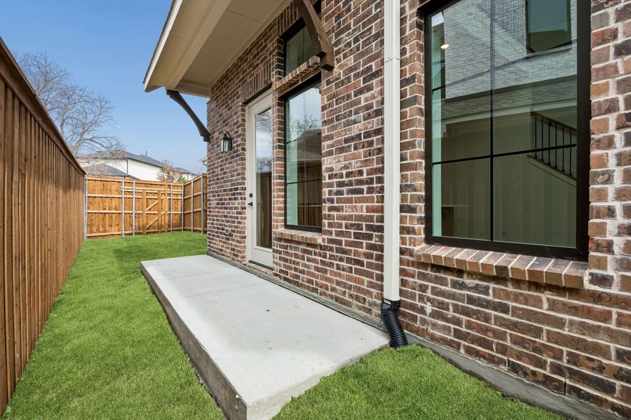 Exterior details and patio area of a home in Newman Village Townhomes, Frisco (Image 3).