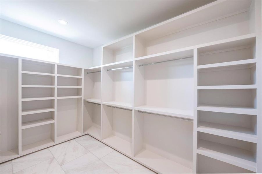 Spacious closet with light tile floors Spacious closet with light tile floors