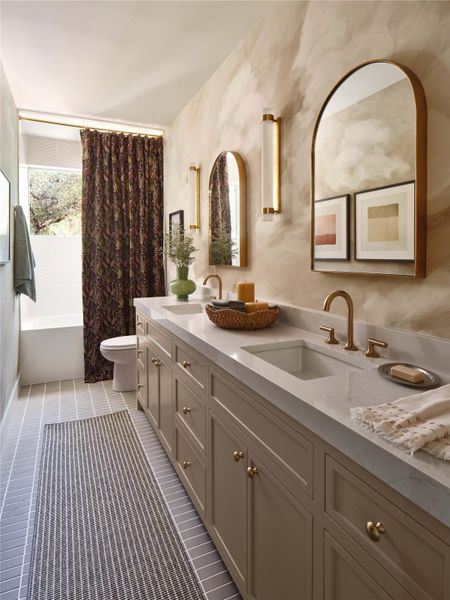 The deep colors of the custom shower curtain enhances the elegant Statuario Gold Quartz counters.