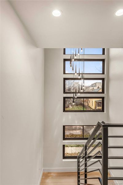 Light-filled staircase from ground floor to top, with a grand chandelier!