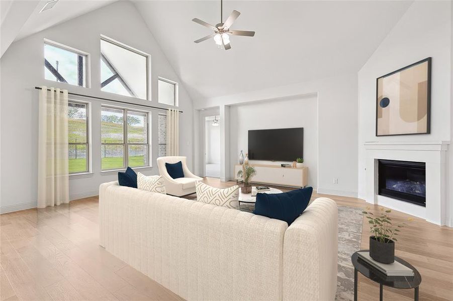 Living room featuring ceiling fan, light hardwood / wood-style flooring, and high vaulted ceiling