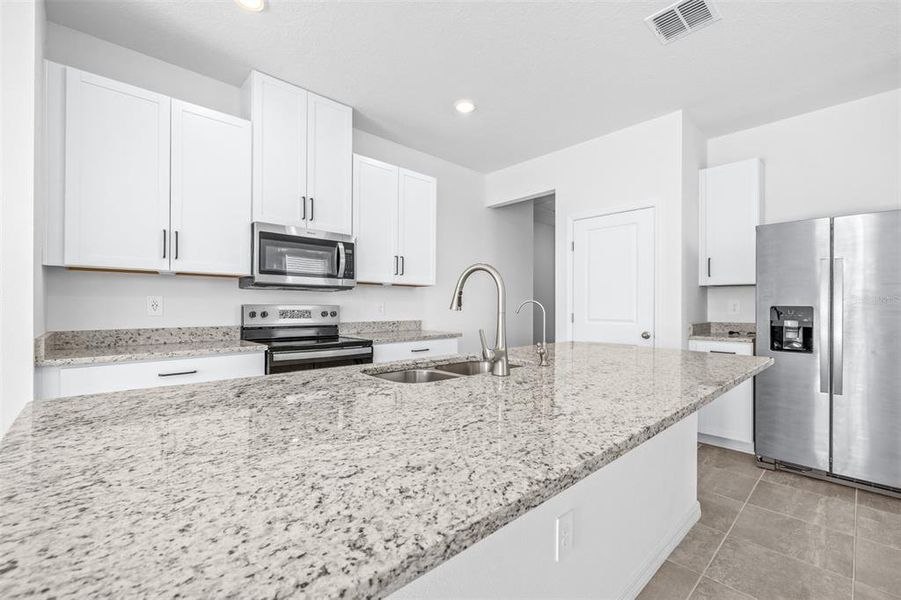 Furnished interior view inside a new home in The Grove at Stuart Crossing - Premier Series, Bartow (Image 10).