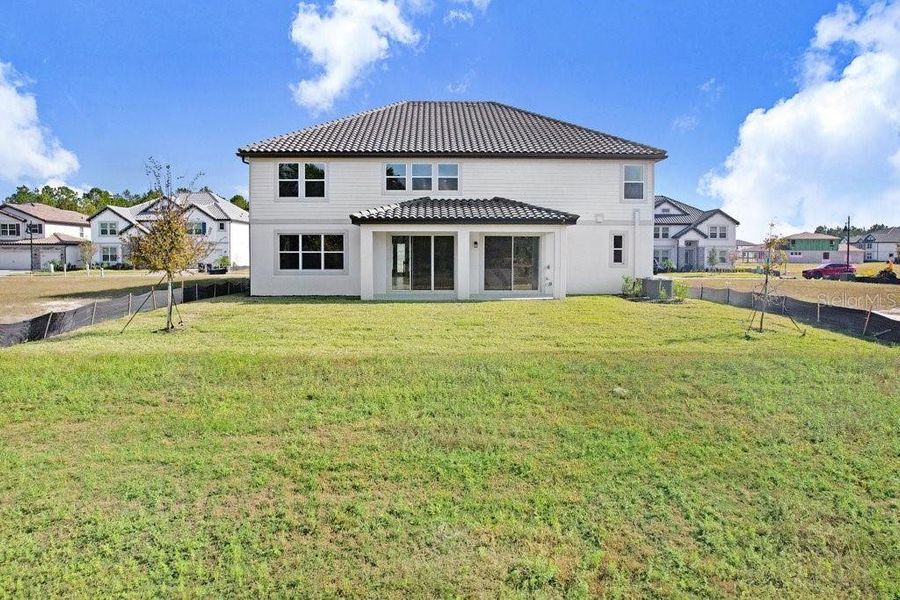 Front exterior of a new home in Shortgrass at Two Rivers, Zephyrhills, FL, highlighting curb appeal (Image 34). Front exterior of a new home in Shortgrass at Two Rivers, Zephyrhills, FL, highlighting curb appeal (Image 34).