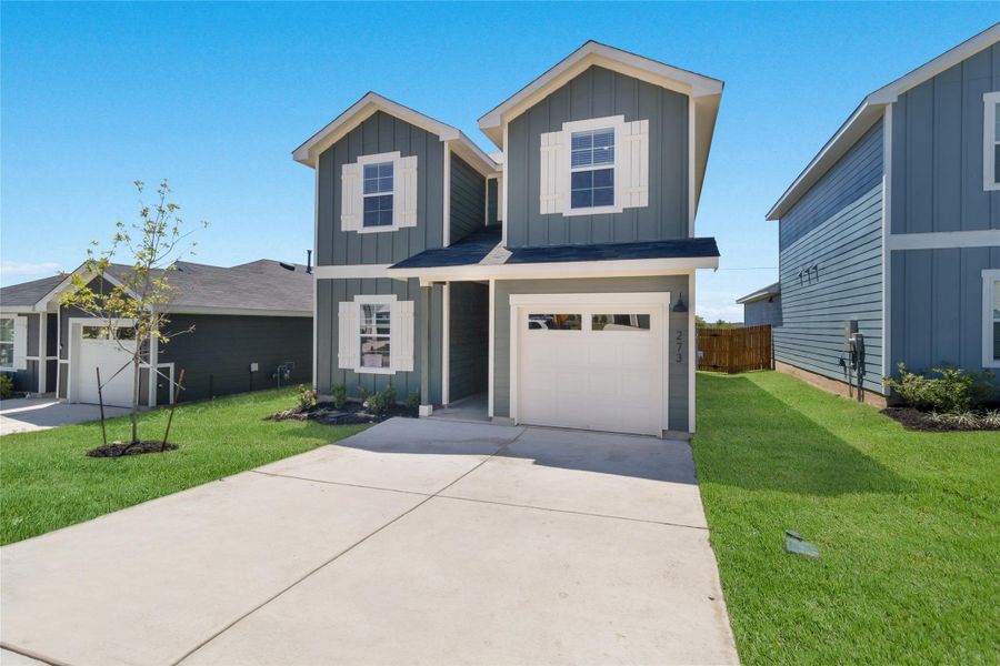 Front exterior of a new home in Marigold, Uhland, TX, highlighting curb appeal (Image 14).