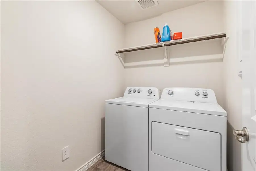 Convenient laundry area located just off the kitchen. Both the washer and dryer convey with the home.