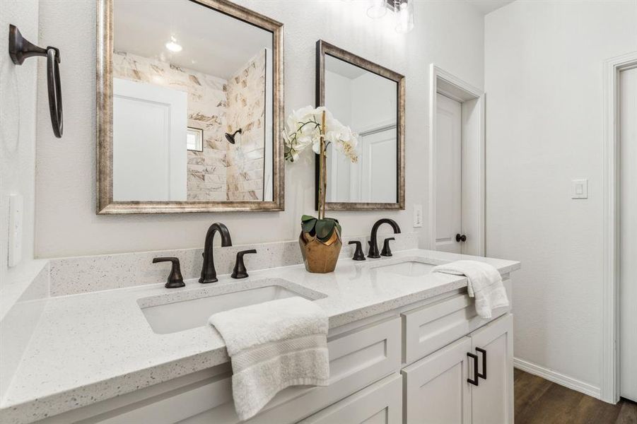 Bathroom with hardwood / wood-style flooring and dual bowl vanity