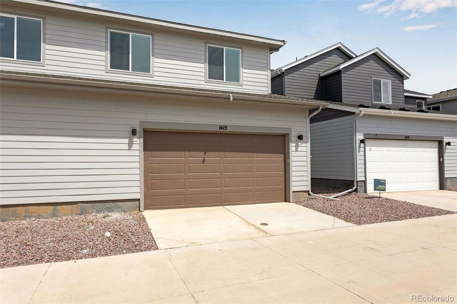 Front exterior of a new home in Sugar Mill Village, Longmont, CO, highlighting curb appeal (Image 18). Front exterior of a new home in Sugar Mill Village, Longmont, CO, highlighting curb appeal (Image 18).
