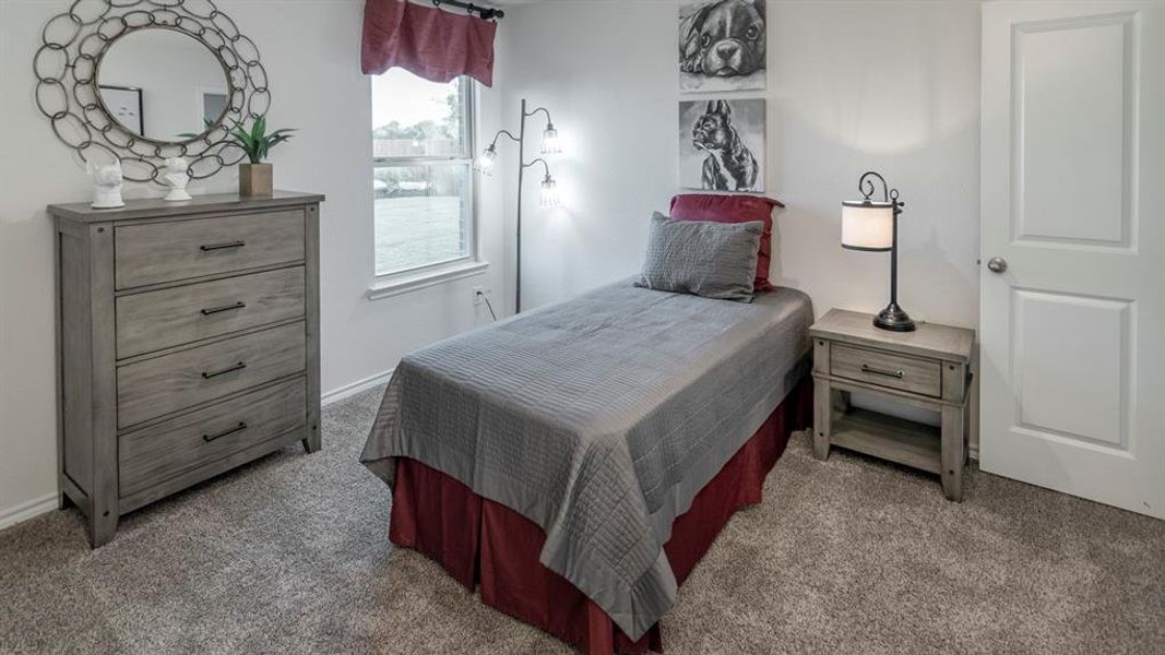 Carpeted bedroom featuring baseboards