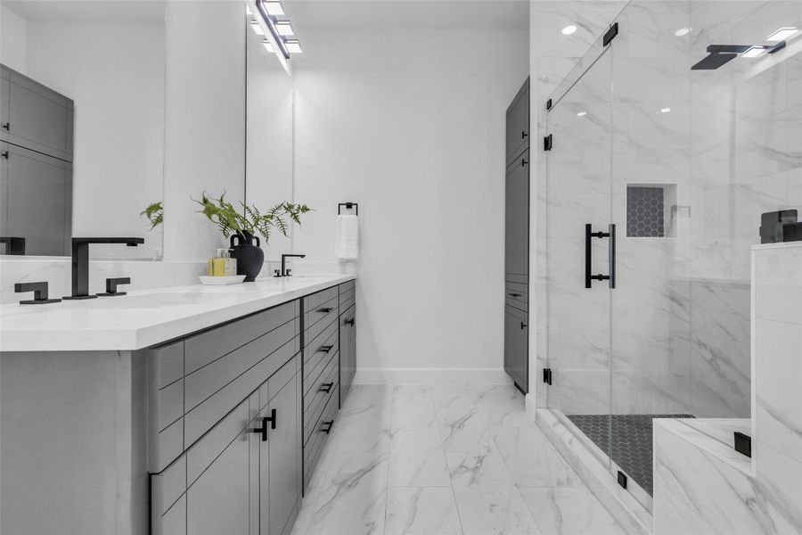 This elegant bathroom offers a sleek double sink vanity, perfect for a stress-free morning routine. This elegant bathroom offers a sleek double sink vanity, perfect for a stress-free morning routine.