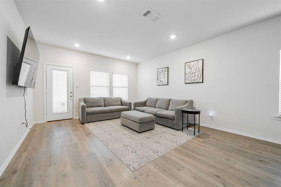 Living room featuring recessed lighting and light LVP floors Living room featuring recessed lighting and light LVP floors