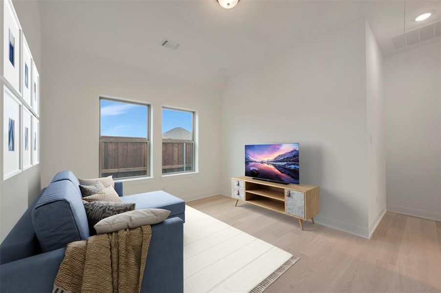 Versatile bonus room featuring light wood-finish flooring, recessed lighting, and two windows
